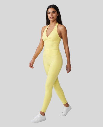 Full body front view of woman wearing Contour Yoga Leggings with matching Contour activewear in yellow
