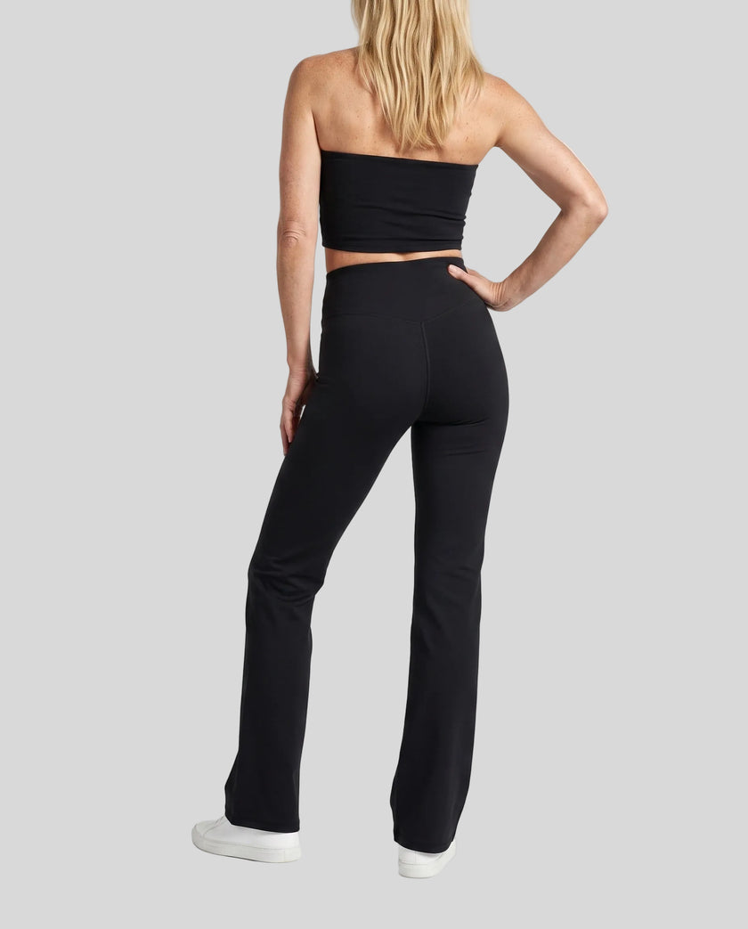 Model wearing the Contour Yoga Pants in Black, back full body view