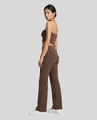 Back angle view of a model wearing the Contour Yoga Pants in Brown