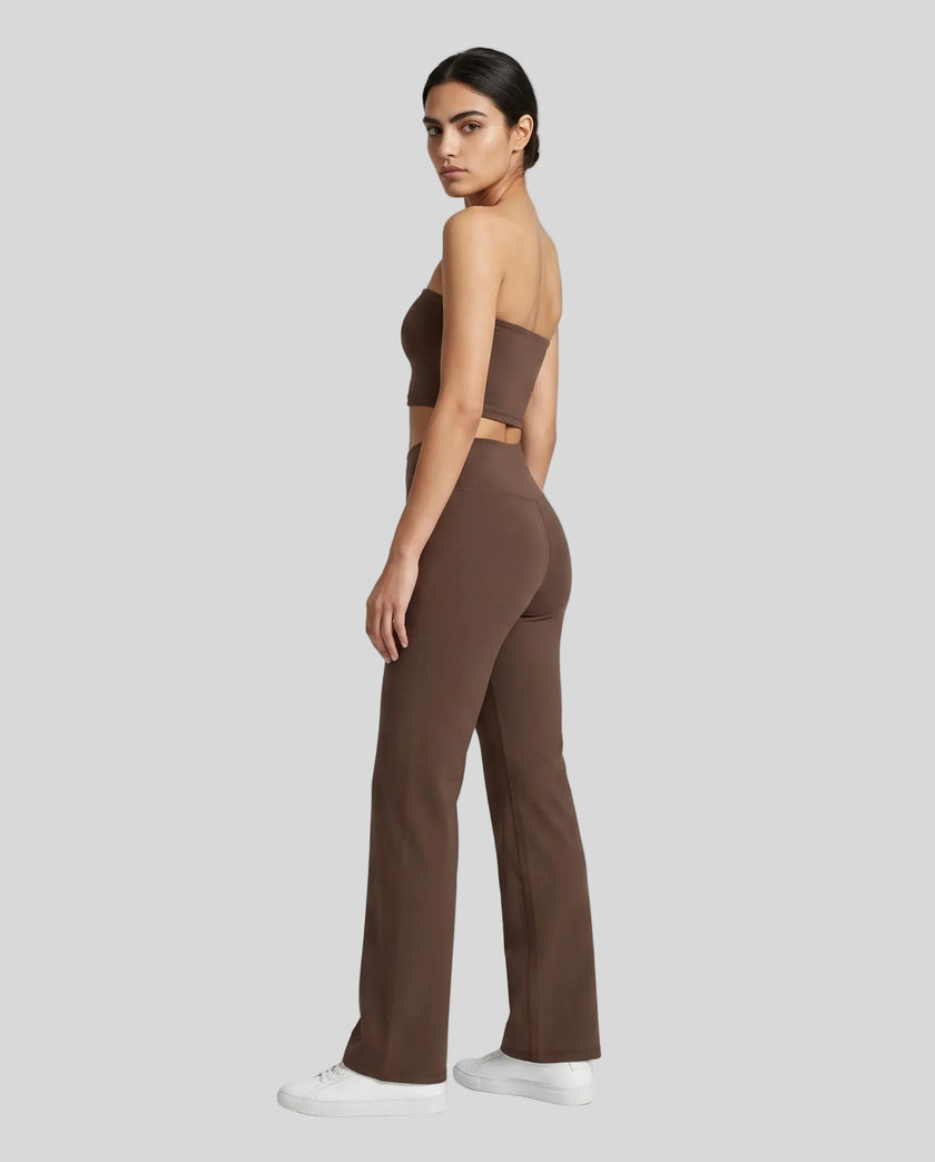 Back angle view of a model wearing the Contour Yoga Pants in Brown