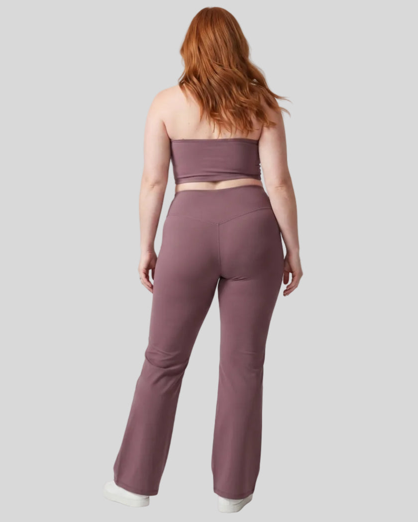 Model wearing the size large Contour Yoga Pants in Plum Purple, back full body view