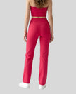 Model wearing the Contour Yoga Pants in Rose Red, back lower body view