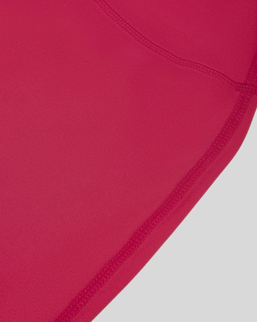 Side view highlighting the hip fit and straight-leg silhouette of the Contour Yoga Pants in Rose Red