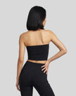 Back view of a model wearing the Contour Yoga Tube Top in Black