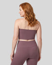Back view of a model wearing the Contour Yoga Tube Top in Plum Purple
