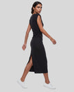 Woman wearing the ContourEase Ruched Maxi Dress in Black, back angle view showing the streamlined silhouette