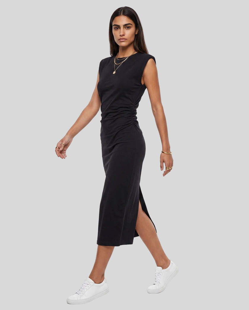 Woman wearing the ContourEase Ruched Maxi Dress in Black, angled front view highlighting ruched waist detail