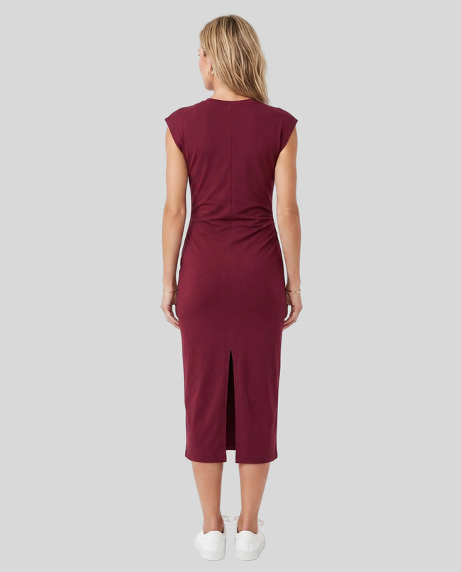 Woman wearing the ContourEase Ruched Maxi Dress in Wine Red, back view showing the streamlined silhouette