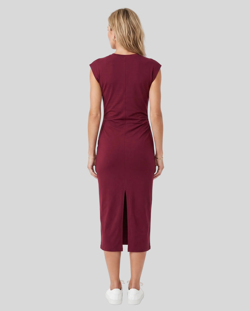 Woman wearing the ContourEase Ruched Maxi Dress in Wine Red, back view showing the streamlined silhouette