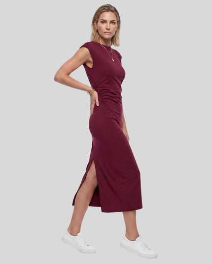 Woman wearing the ContourEase Ruched Maxi Dress in Wine Red, angled front view highlighting ruched waist detail