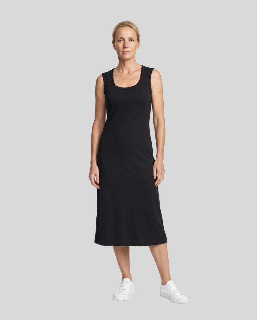 Woman wearing the ContourEase Sleeveless Maxi Dress in Black, front view showing slim body-skimming silhouette