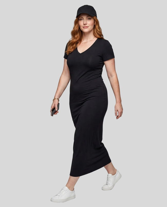 Woman wearing the ContourEase V-Neck Maxi Dress in Black, angled front view showing body-skimming silhouette