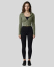 Model wearing a army green ContourZip Ribbed Jacket and black leggings in a clean studio setting