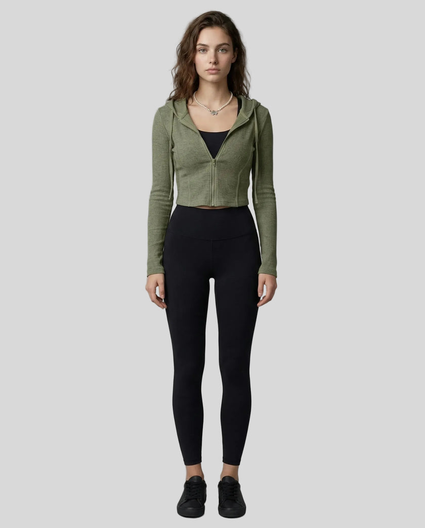 Model wearing a army green ContourZip Ribbed Jacket and black leggings in a clean studio setting