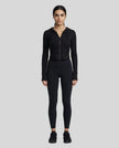 Model wearing a black ContourZip Ribbed Jacket and black leggings in a clean studio setting