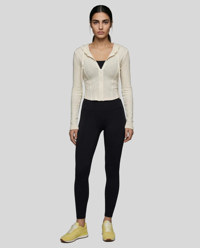 Model wearing a khaki ContourZip Ribbed Jacket and black leggings in a clean studio setting