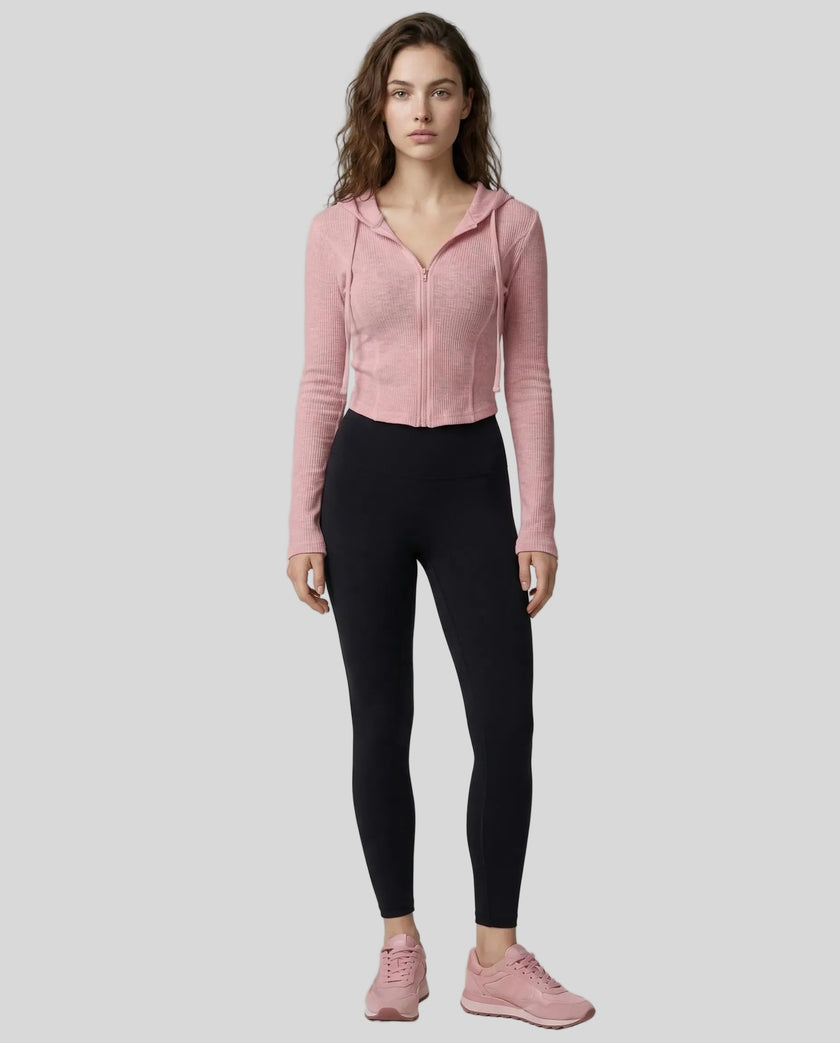 Model wearing a pink ContourZip Ribbed Jacket and black leggings in a clean studio setting