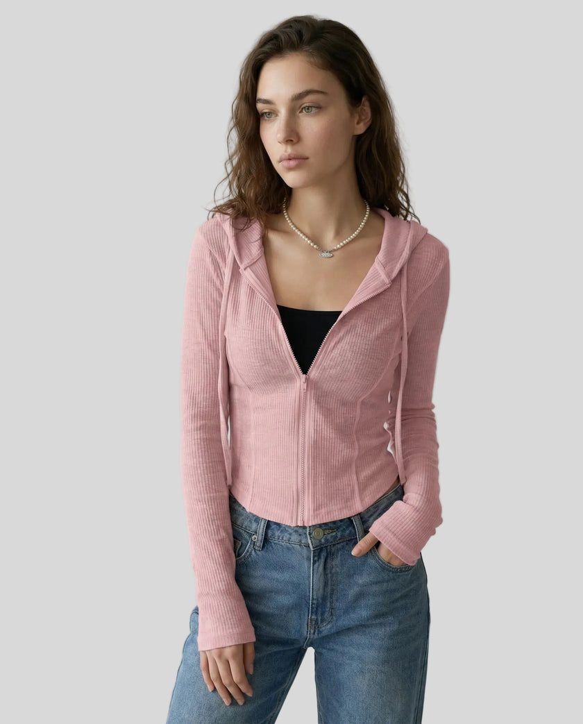 Mid shot of model wearing a pink ContourZip Ribbed Jacket with jeans in a clean studio setting