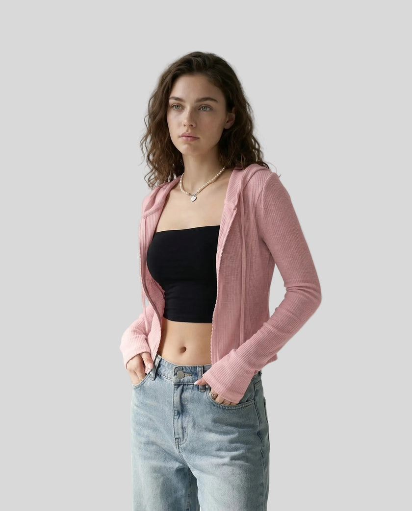 Mid shot of model wearing an open front pink ContourZip Ribbed Jacket with jeans in a clean studio setting