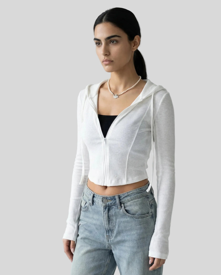 Mid shot of model wearing a white ContourZip Ribbed Jacket with jeans in a clean studio setting