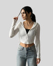 Mid shot of model casually wearing a white ContourZip Ribbed Jacket with jeans in a clean studio setting