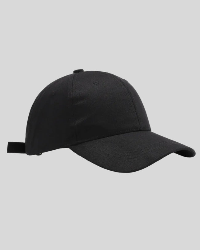 CoreForm Essential Cap in black front angle view with structured crown and curved brim