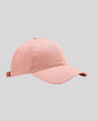 CoreForm Essential Cap in blush pink front angle view with structured crown and curved brim
