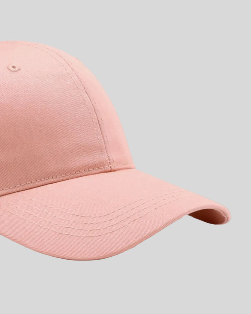 CoreForm Essential Cap in blush pink right side close-up highlighting curved brim and panel structure