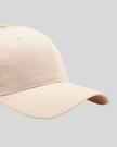 CoreForm Essential Cap in cream right side close-up highlighting curved brim and panel structure