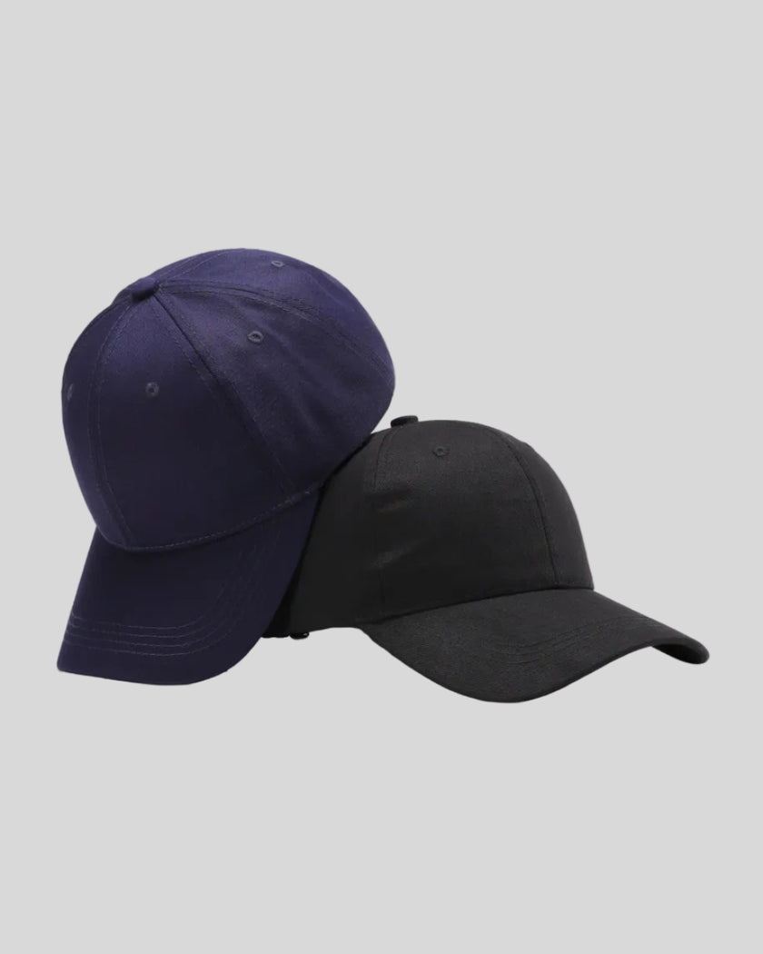 CoreForm Essential Cap in dark blue and black front angle view with structured crown and curved brim