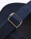 CoreForm Essential Cap in dark blue adjustable strap close-up showing stitching and fabric texture