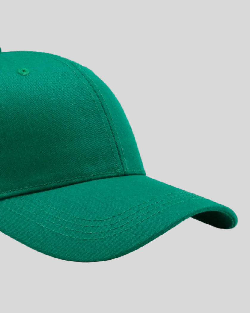 CoreForm Essential Cap in dark green right side close-up highlighting curved brim and panel structure