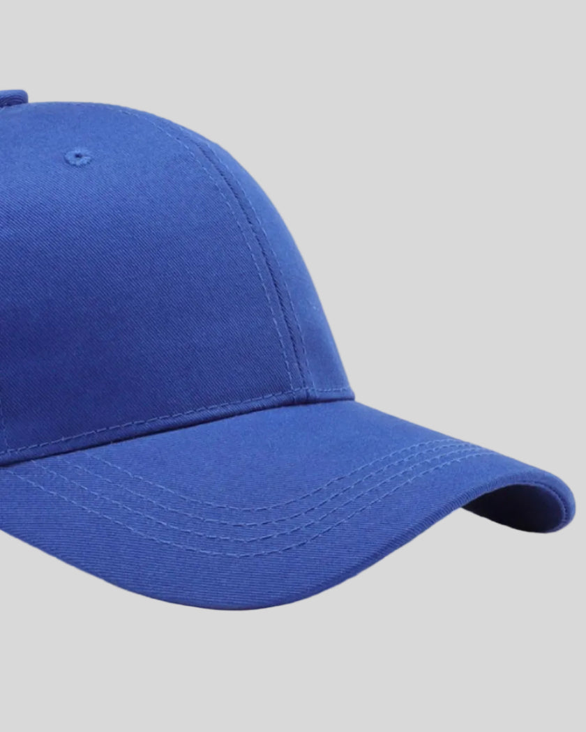CoreForm Essential Cap in royal blue right side close-up highlighting curved brim and panel structure