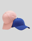 CoreForm Essential Cap in blush pink and royal blue front angle view with structured crown and curved brim
