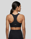 CoreForm Sports Bra in black, back view styled on model