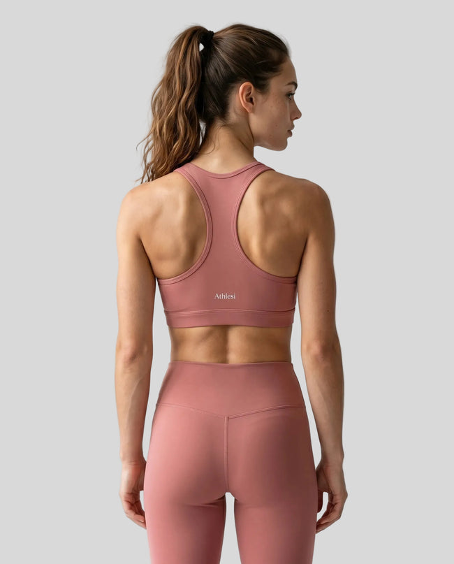 CoreForm Sports Bra in brick red, back view styled on model