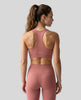 CoreForm Sports Bra in brick red, back view styled on model