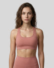 CoreForm Sports Bra in brick red, front view styled on model