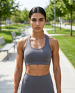 CoreForm Sports Bra in dark purple, front view styled on model at the park