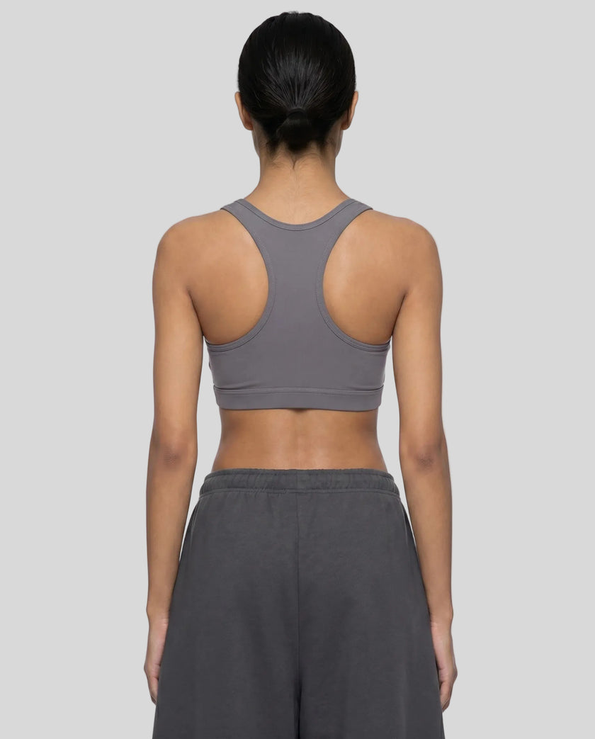 Back view of woman wearing Athlesi dark purple CoreForm sports bra