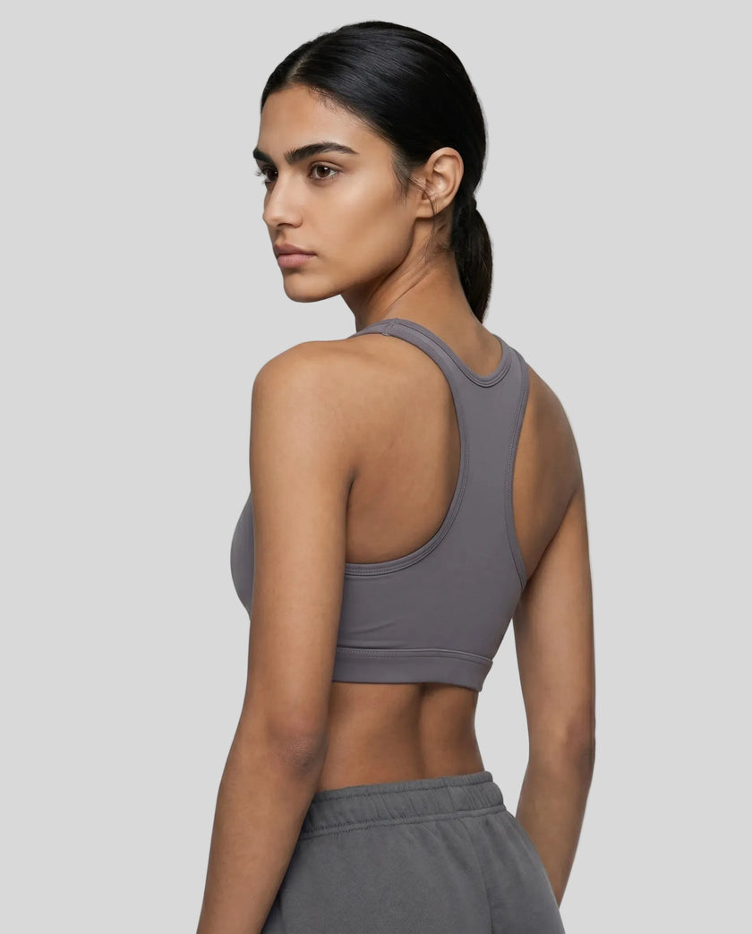 Back angle view of woman wearing Athlesi dark purple CoreForm sports bra