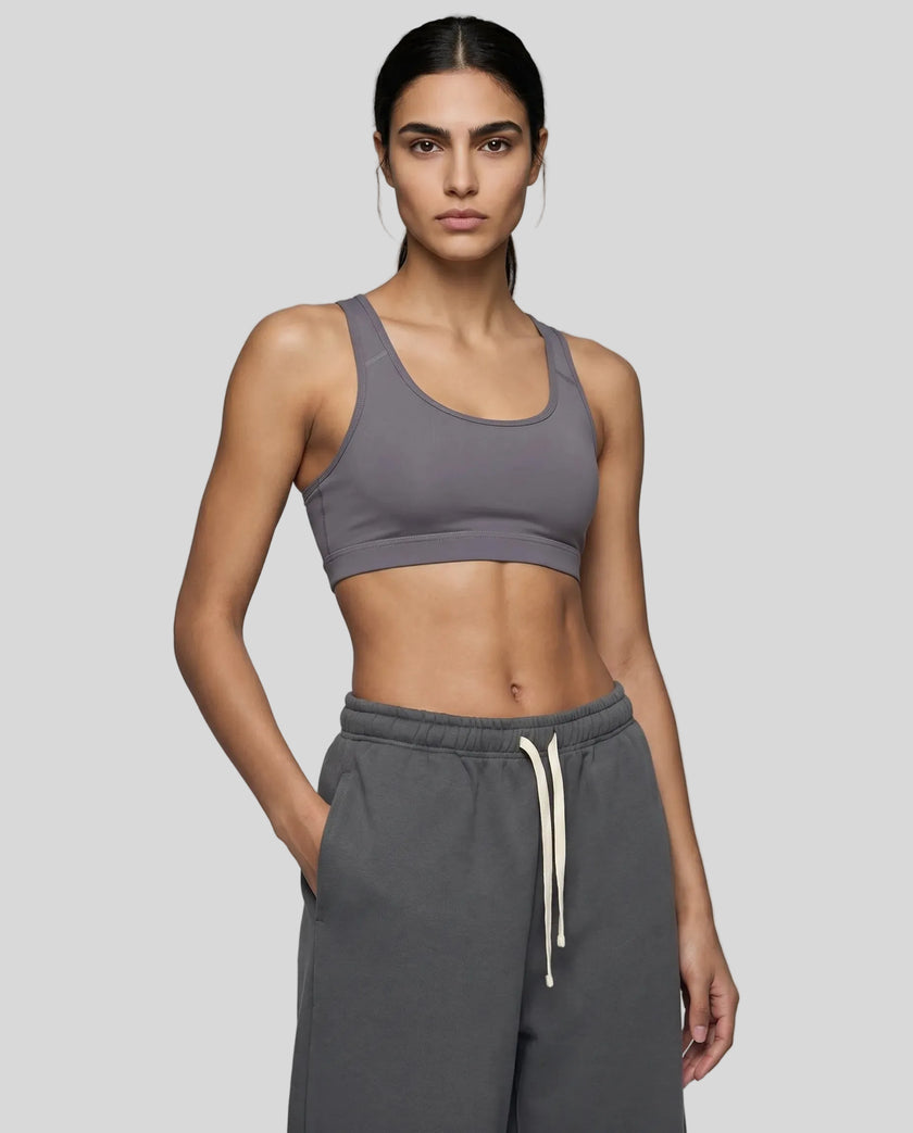 Front angle view of woman wearing Athlesi dark purple CoreForm sports bra