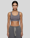 Front view of woman wearing Athlesi dark purple CoreForm sports bra