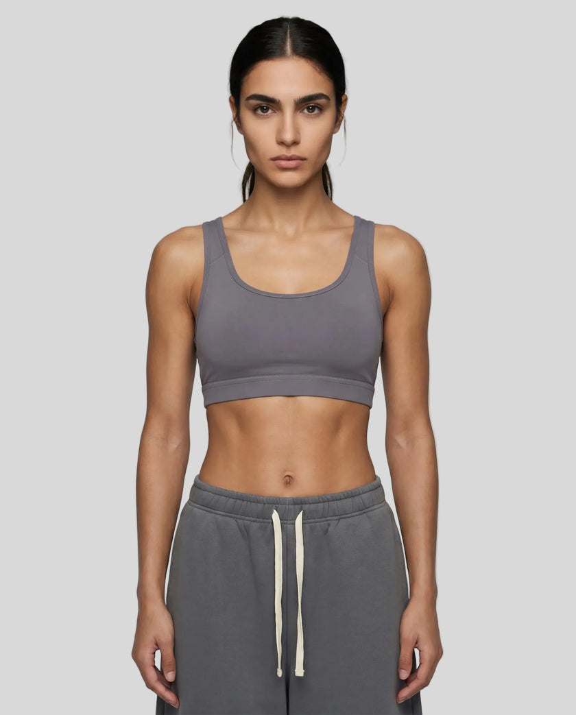 Front view of woman wearing Athlesi dark purple CoreForm sports bra