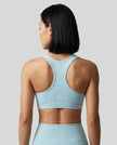 CoreForm Sports Bra in sky blue, back view styled on model