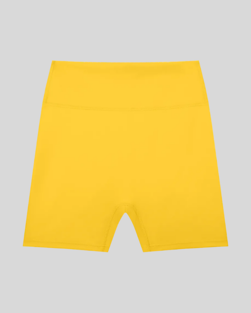 CoreLine Biker Shorts in yellow, flatlay front view