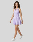 Model wearing purple Athlesi CoreLine court dress front angle