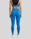 CoreLine High-Waisted Leggings in colorful blue, back view styled on model