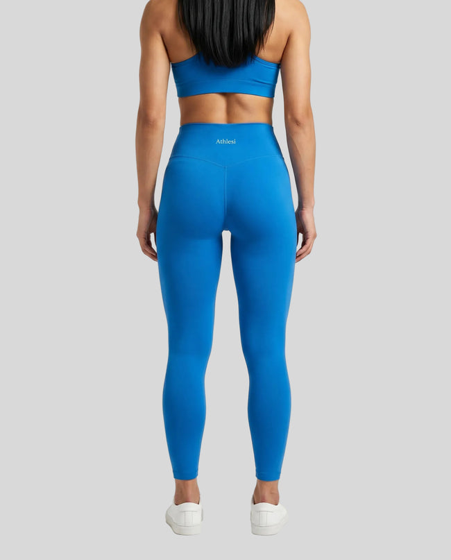 CoreLine High-Waisted Leggings in colorful blue, back view styled on model