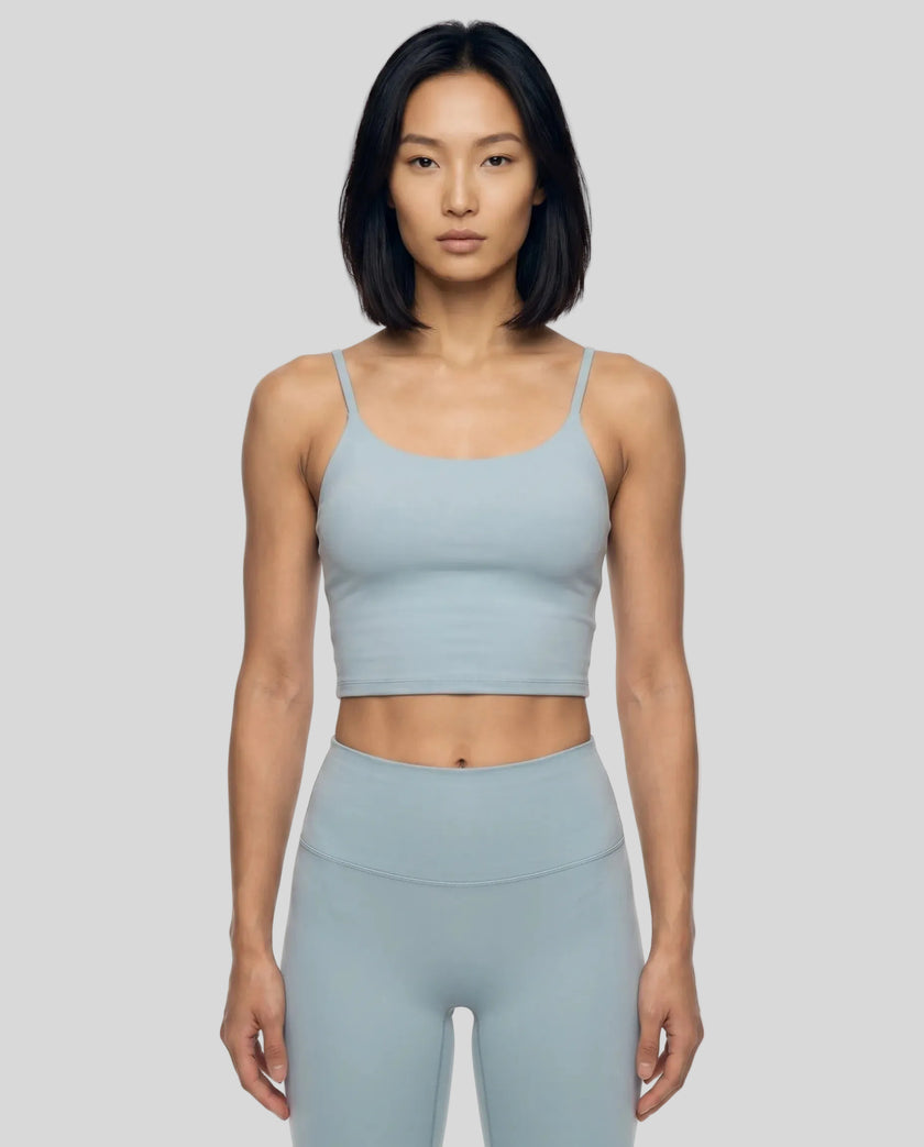 CoreLine Sports Bra in haze blue, mid body front view styled for activewear